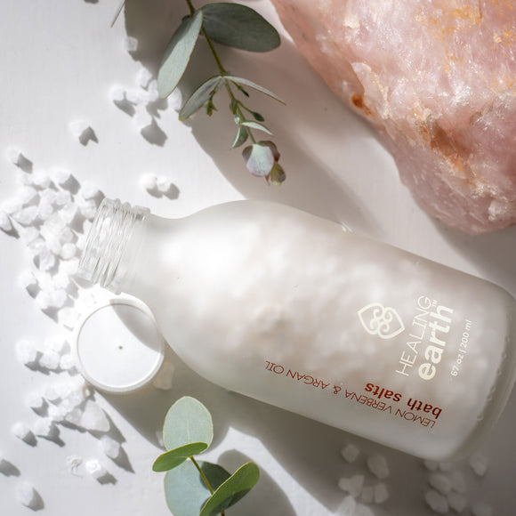 Healing Earth Lemon Verbena and Argan Oil Bath Salt Crystals 200ml in a white frost glass bottle with a twist cap. Sold by SR Amenities Hotel and Spa Suppliers.