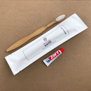 Healing Earth Eco-friendly bamboo toothbrush and mini toothpaste in an eco-friendly, biodegradable 100% stone paper sachet.