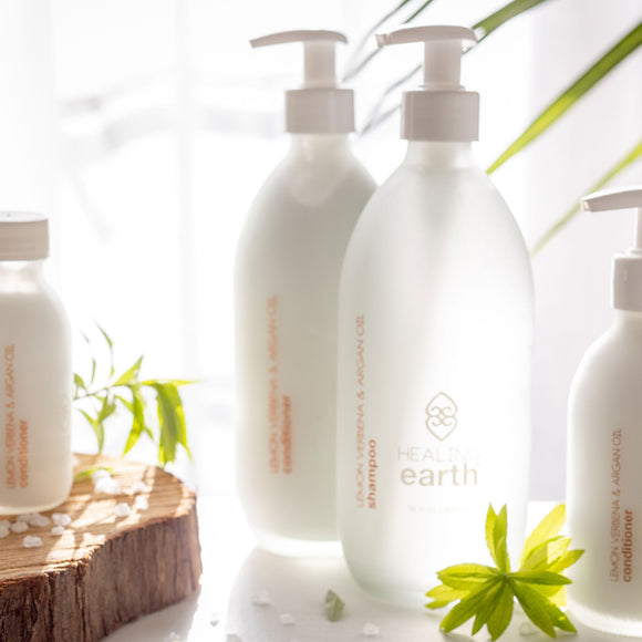 Healing Earth Lemon Verbena and Argan Oil Shampoo 500ml in a white frost glass bottle with a pump dispenser. Sold by SR Amenities Hotel and Spa Suppliers.
