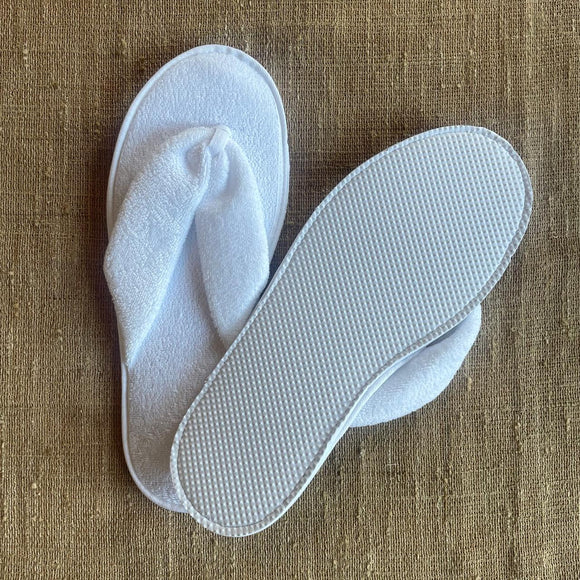 White washable and reusable thong style slipper made from terry towel fabric with textured water resistant sole. Shop at www.sramenities.co.za