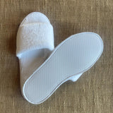 White fleece open toe slipper with EVA non-slip sole. 