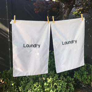 White laundry bag with drawstring and embroidered text, "Laundry". Sold by SR AMenities Hotel & Spa Supplies.