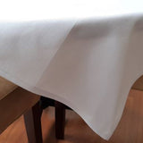 White poly-cotton Conlyn weave tablecloth with a  1 cm hem. Sold by SR Amenities Hotel and Spa Supplies.